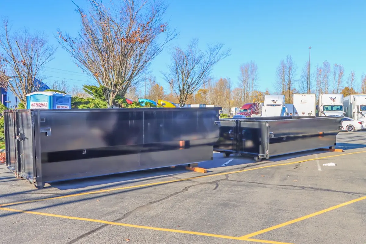 Professional dumpster rental service with roll-off container on residential driveway in Waikoloa Village